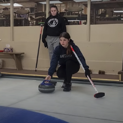 Two curlers participate in practice drills at the Racine Curling Club (2024).