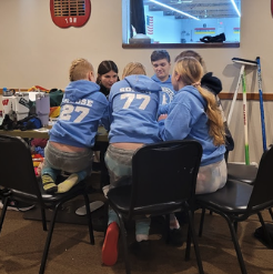 Racine Juniors play a card game in between curling games.